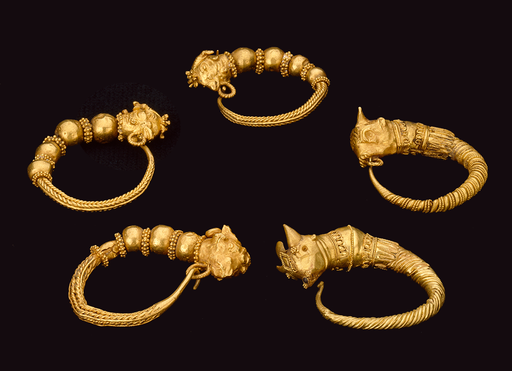 Five ornate gold earring hoops, with animal head designs