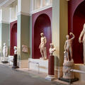Marble sculptures of figures on display in a long gallery at the Ashmolean Museum