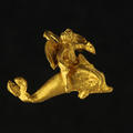 Ancient Greek gold pendant in the shape of Eros riding a dolphin