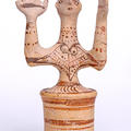 Ceramic figurine of a goddess with upraised arms