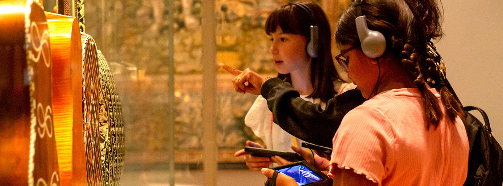 Families doing the Ashmolean Adventure in summer 2022 in the music gallery 