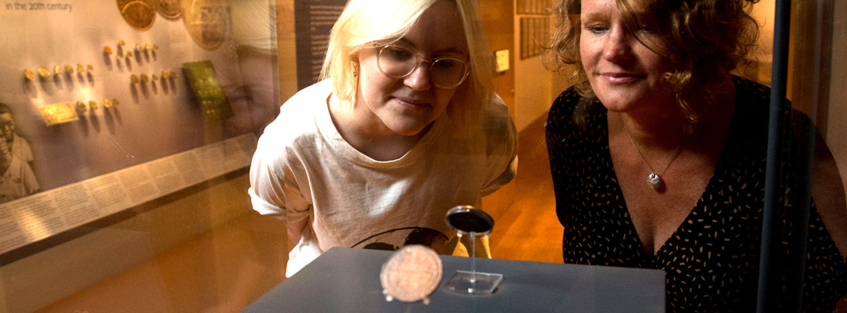 Visitors looking at the Oxford Crown coin in Money Gallery