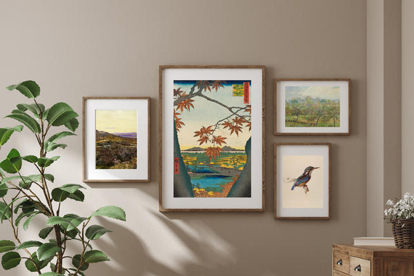A neutral coloured room with art prints hung in frames on a wall
