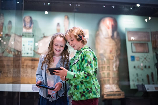 Two children in the Egypt gallery holding multimedia guides