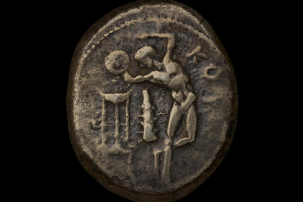 Ancient Greek silver coin with a discus thrower