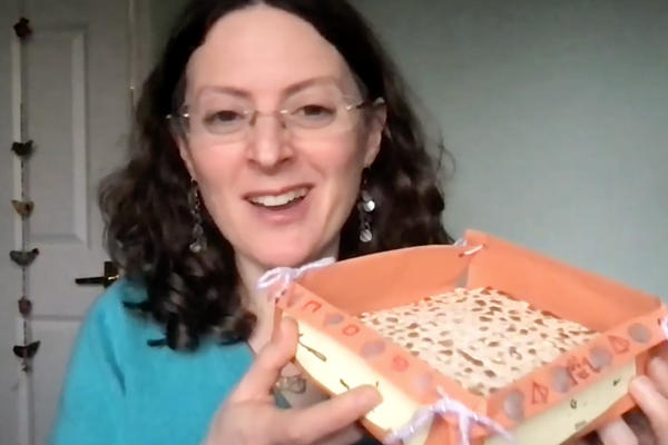 A still from a video showing a woman holds up a homemade basket