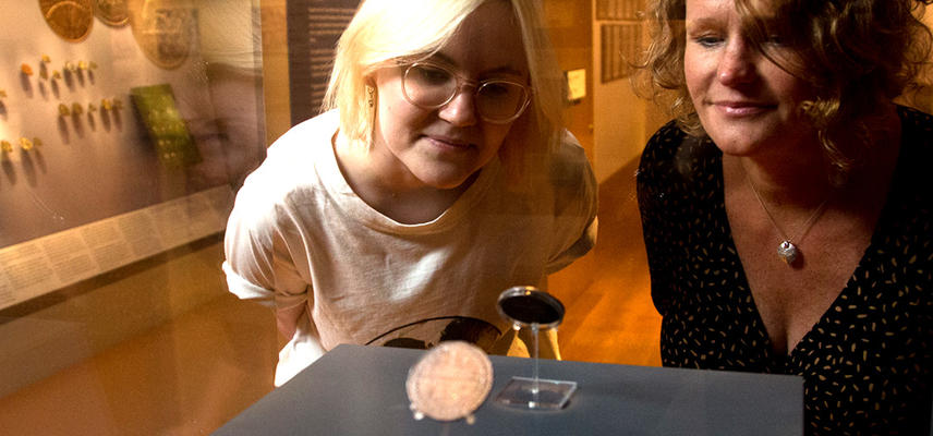 Visitors looking at the Oxford Crown coin in Money Gallery