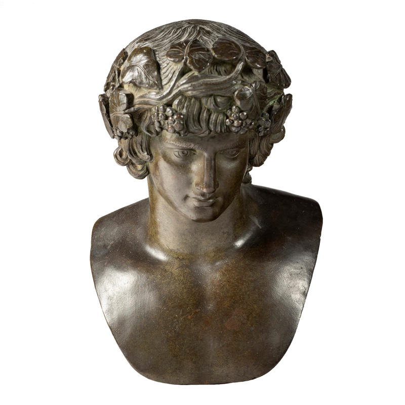 An 18th-century bronze bust of the Roman boy god Antinous, dressed as the god Bacchus, with fruits and flowers in his hair