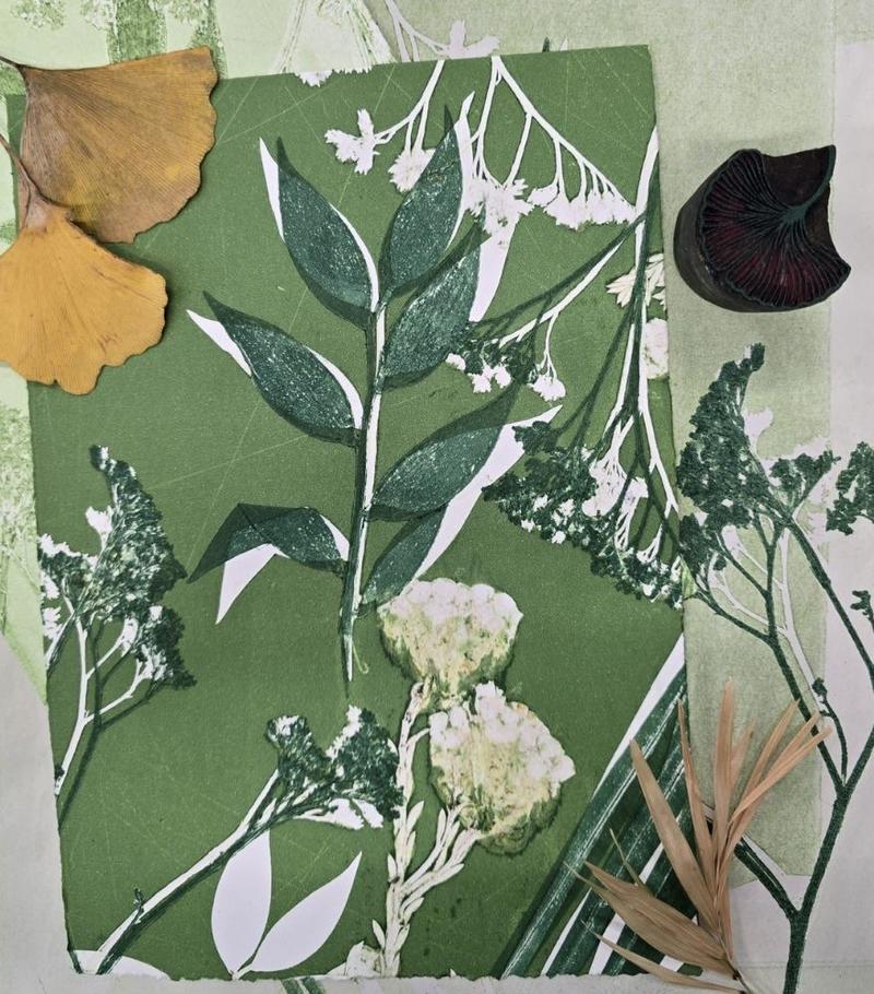 A piece of bright green paint with several plant motifs printed in overlapping layers