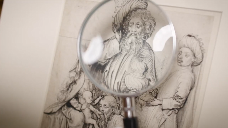 A close up of a magnifying glass over a drawing