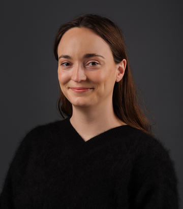 Staff photo of Research Fellow Dr Eliza Goodpasture against a black background