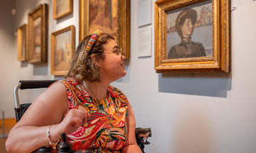 A visitor viewing a painting in the Sickert Gallery at the Ashmolean