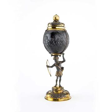 A tall ornate cup and lid made from gold fittings and a painted coconut